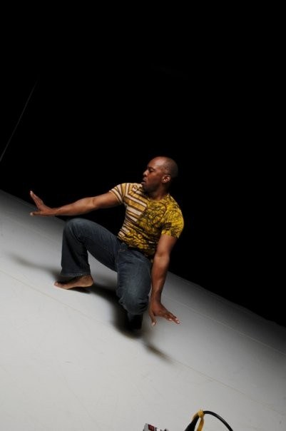 Boris Willis kneeling with one arm sweeping outward