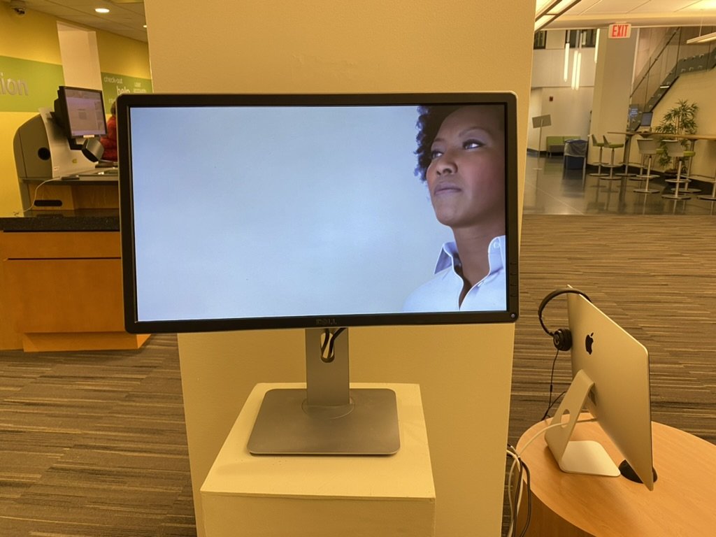 A MetaHuman face on a monitor in the Encounters installation
