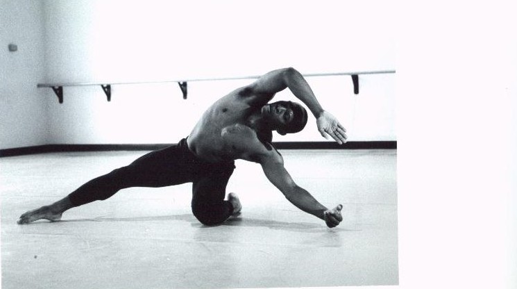 Black-and-white photograph of Boris Willis in a deep floor lunge, one arm arcing across his body