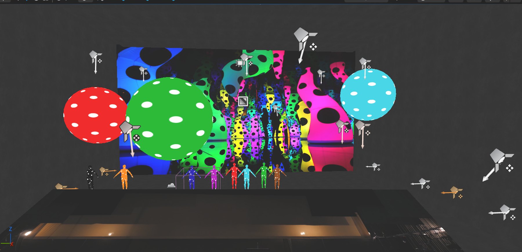 Front-on view of the set in the editor: polka-dot spheres over a dotted backdrop, dancers lined up, light-rig gizmos around the stage