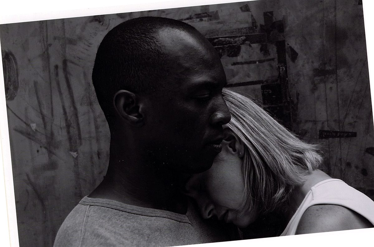 Black-and-white photograph of Cynthia McLaughlin resting her head against Boris Willis in Enter Race