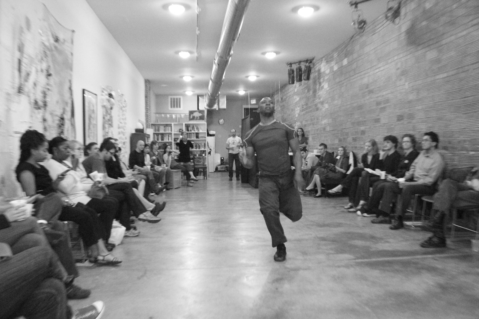 Boris Willis striding toward the camera down the center of the room