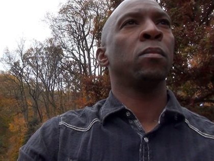 Boris Willis looking upward in an autumn landscape